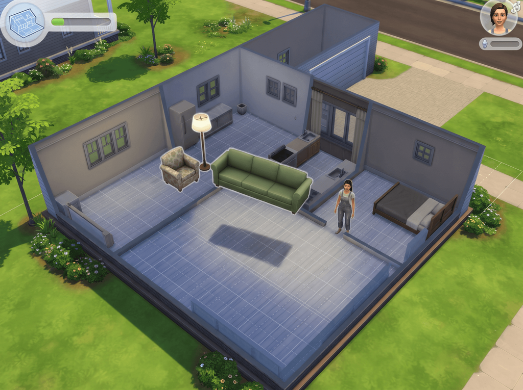 Illustration of a roofless house seen from above in build mode, with a floor grid and a sofa and armchair floating above the rooms
